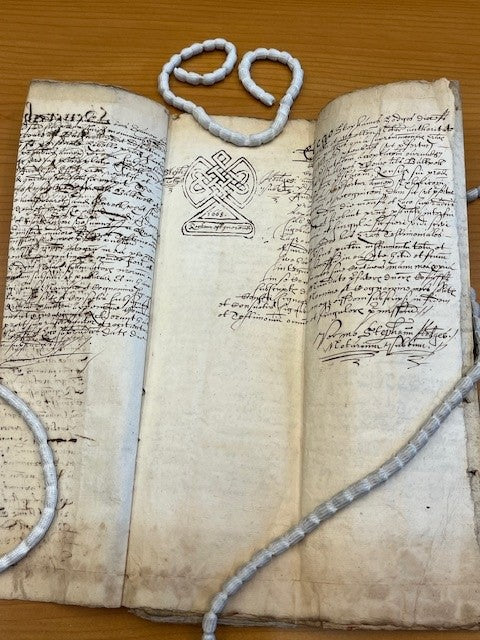 A very old document with the embellished symbol of a Notary.